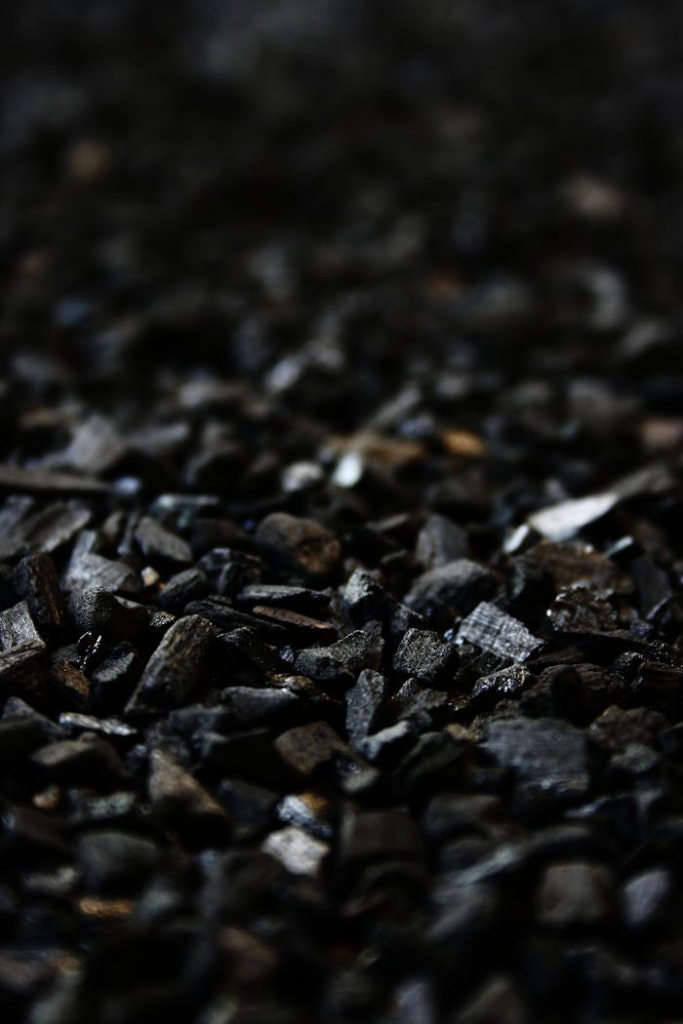 carbon black charcoal grill briquettes 48884 Detailed close-up of charcoal briquettes showing textures and shades.